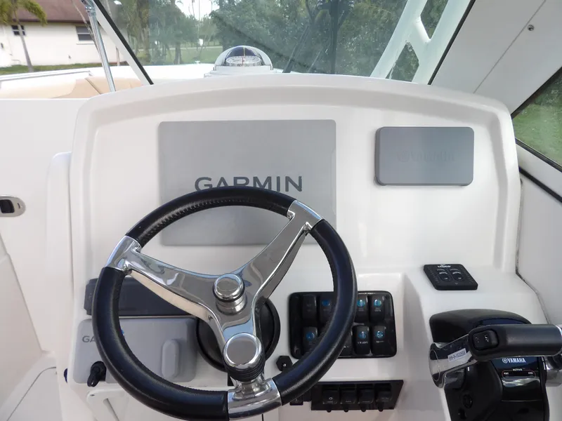 Slide: The Image of Steering wheel and controls of 2020 Sailfish 275 DC boat with Garmin navigation system. - 42
