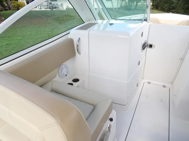 Slide: The Image of Interior of 2020 Sailfish 275 DC boat with beige seating and storage compartment. - 44