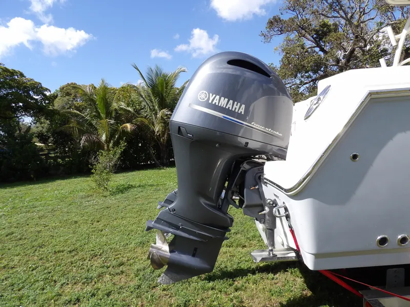 Slide: The Image of Yamaha outboard motor on 2020 Sailfish 275 DC boat, parked on grassy area. - 6