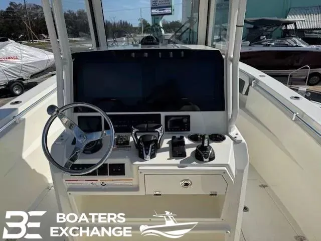 Slide: The Image of Cobia 285 Open Center Console 2025 helm with modern electronics. - 8