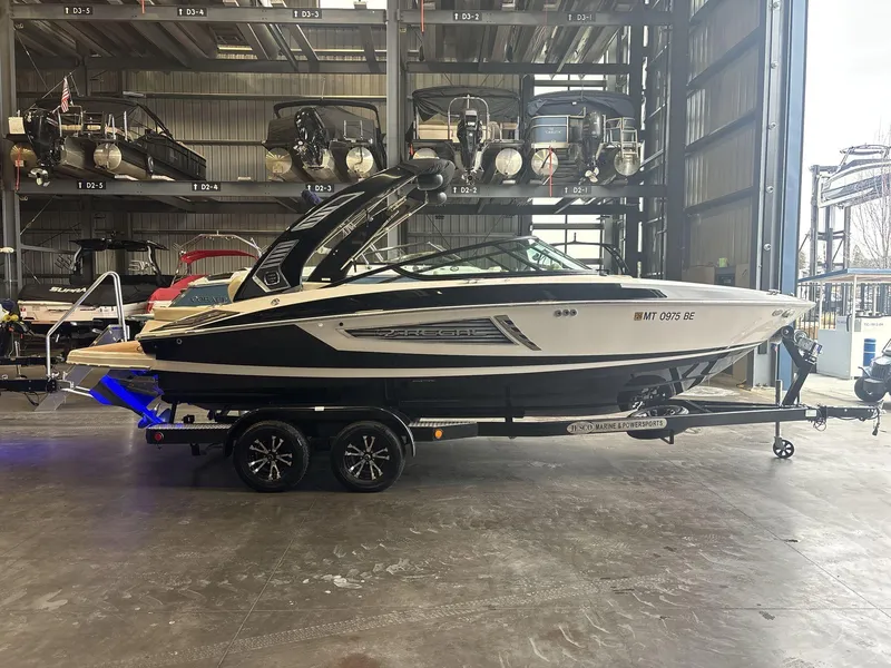 Slide: The Image of 2019 Regal 2300 RX Surf boat on trailer in indoor storage facility. - 1