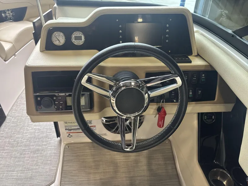 Slide: The Image of 2019 Regal 2300 RX Surf boat dashboard with steering wheel and control panel. - 10