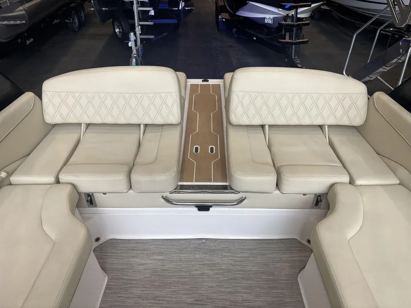 Slide: The Image of 2019 Regal 2300 RX Surf boat interior with beige seating and wood accents. - 12