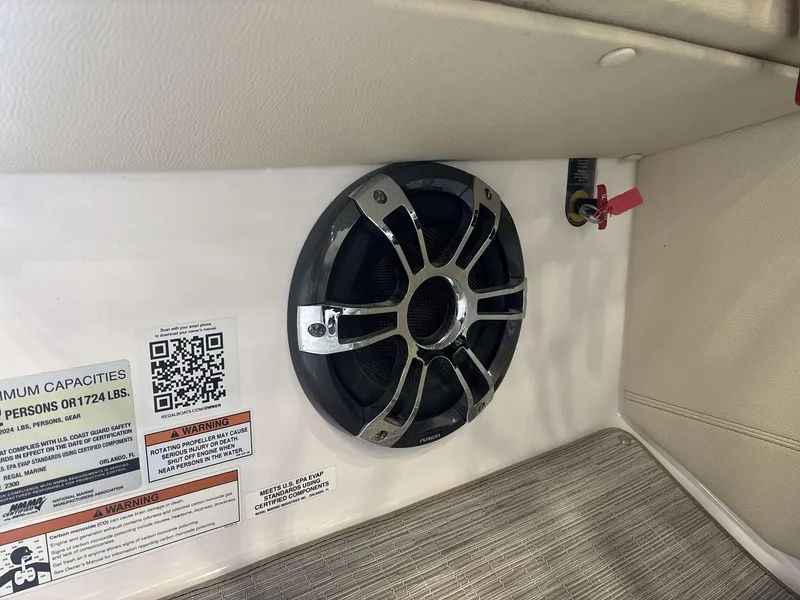 Slide: The Image of Speaker and safety labels inside 2019 Regal 2300 RX Surf boat interior. - 13
