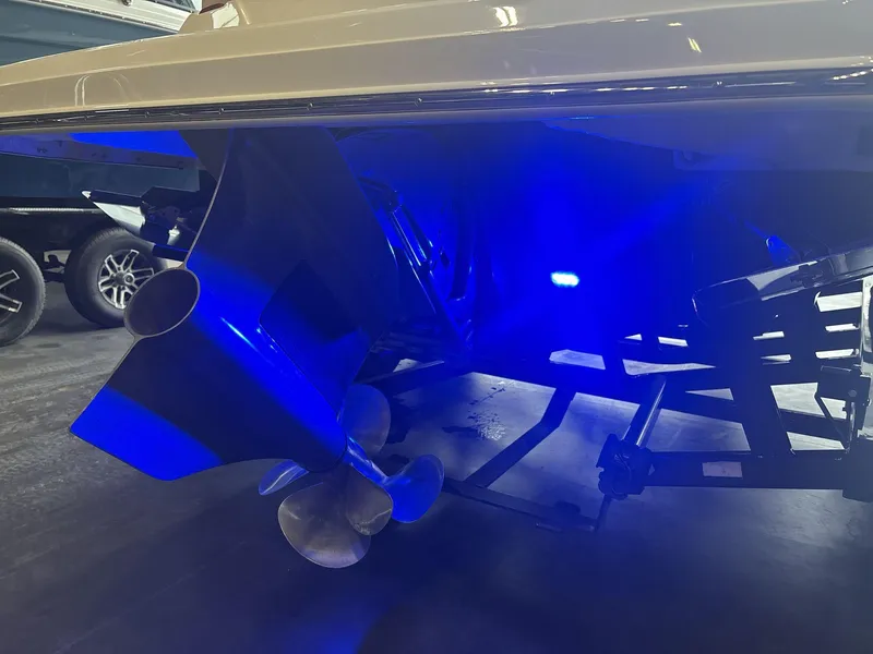 Slide: The Image of 2019 Regal 2300 RX Surf boat with illuminated blue underwater lights. - 15