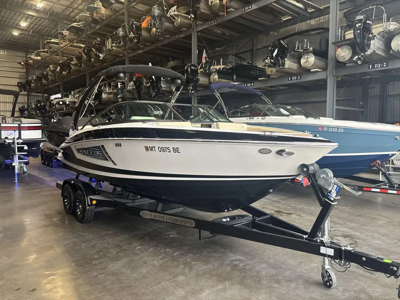 Slide: The Image of 2019 Regal 2300 RX Surf boat on trailer in storage facility. - 2