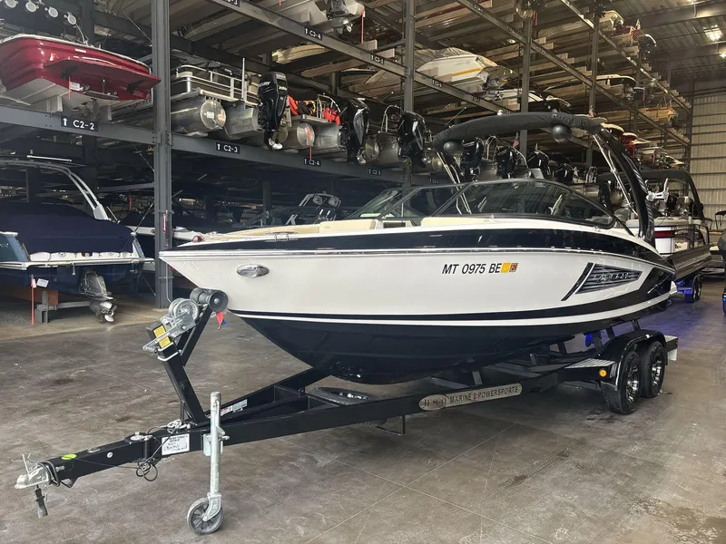 Slide: The Image of 2019 Regal 2300 RX Surf boat on trailer in storage facility. - 3
