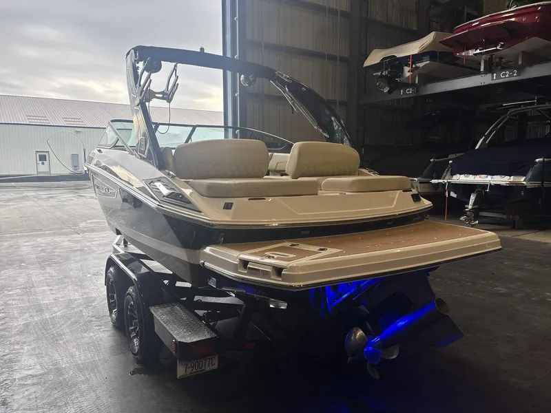 Slide: The Image of 2019 Regal 2300 RX Surf boat in storage, rear view with trailer. - 4
