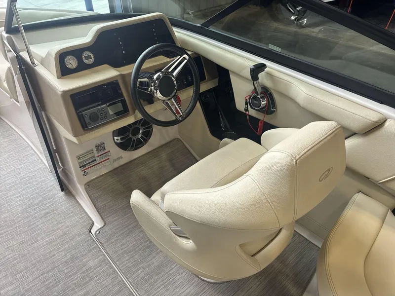 Slide: The Image of Interior of 2019 Regal 2300 RX Surf boat with steering wheel and control panel. - 9