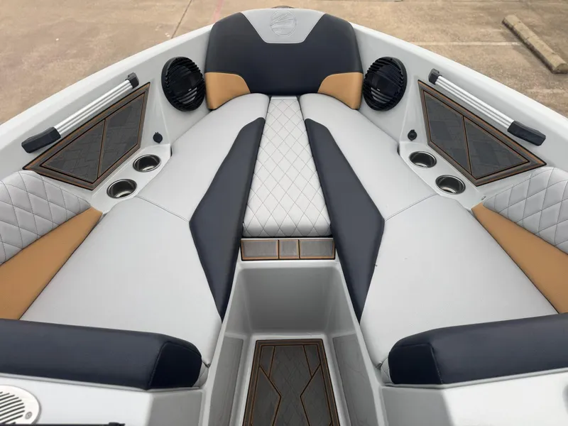 Slide: The Image of 2023 Tigé Z5 boat interior with luxurious seating, cup holders, and speakers. - 16