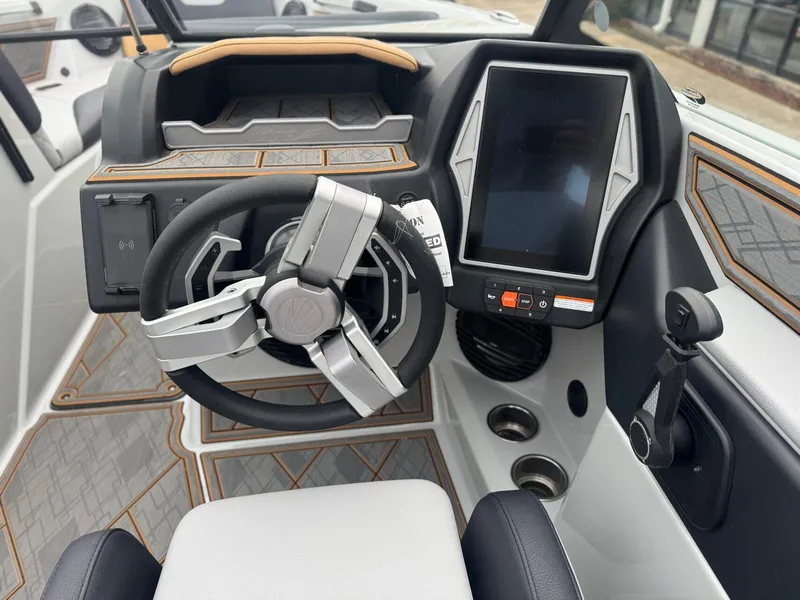 Slide: The Image of 2023 Tigé Z5 boat dashboard with modern steering wheel and touchscreen display. - 18