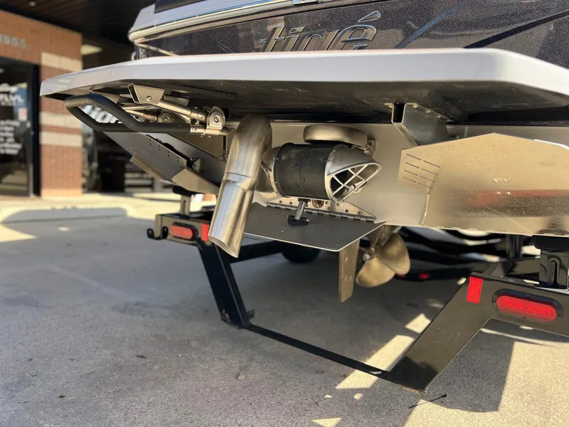 Slide: The Image of 2023 Tigé Z5 boat rear view showing exhaust and propeller details. - 5