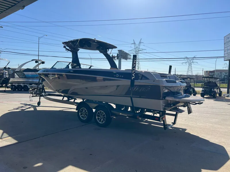 Slide: The Image of 2023 Tigé Z5 boat on trailer in outdoor dealership lot. - 6