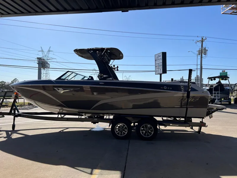 Slide: The Image of 2023 Tigé Z5 boat on trailer, parked outdoors under a canopy. - 7