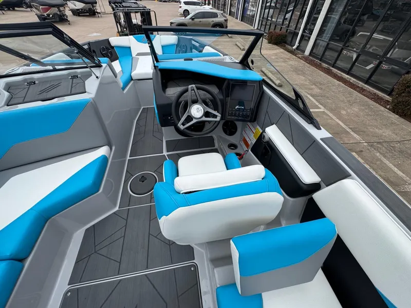 Slide: The Image of 2024 ATX Surf Boats 22 Type-S interior with blue and white seating, modern dashboard, and steering wheel. - 10