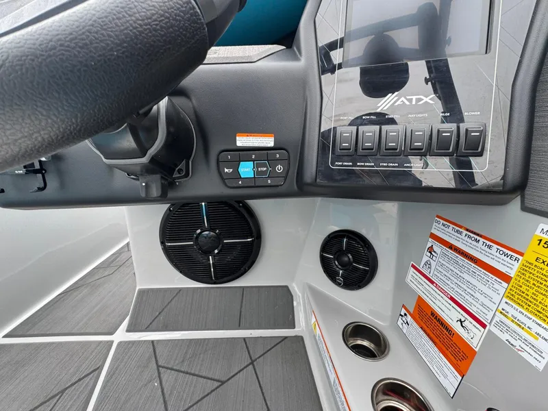 Slide: The Image of 2024 ATX Surf Boats 22 Type-S dashboard with controls and warning labels. - 12