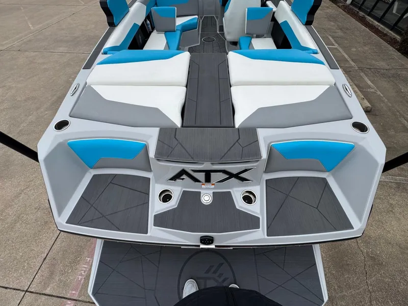 Slide: The Image of 2024 ATX Surf Boats 22 Type-S interior with blue and white seating, viewed from above. - 4