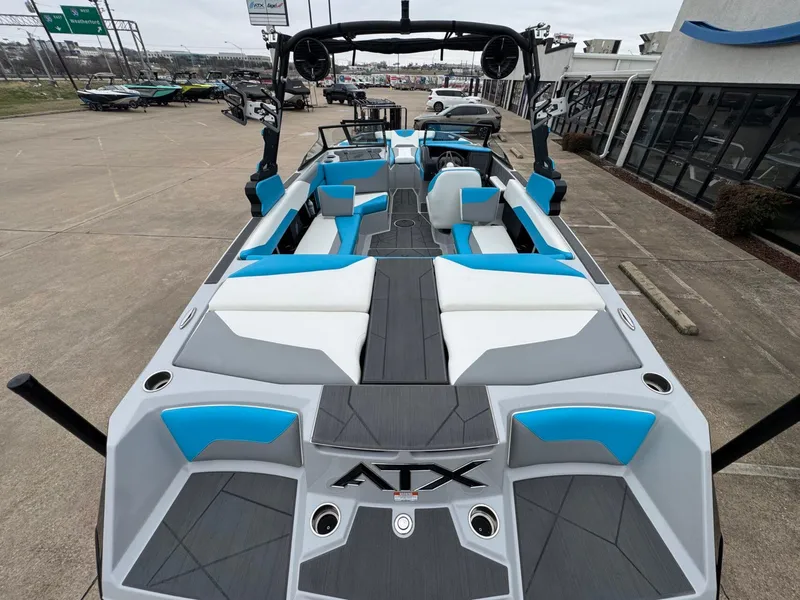 Slide: The Image of 2024 ATX Surf Boats 22 Type-S with blue and white interior, docked outdoors. - 5