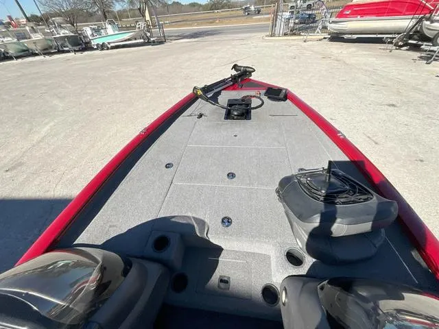 Slide: The Image of 2020 Tracker 195TXW boat deck with red trim, parked outdoors. - 13