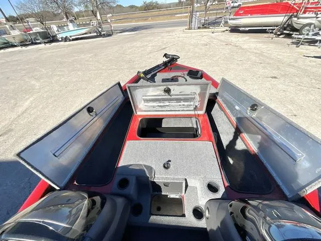 Slide: The Image of 2020 Tracker 195TXW boat interior with open storage compartments and seating. - 14