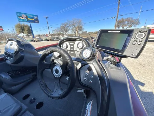 Slide: The Image of Interior view of a 2020 Tracker 195TXW boat dashboard with steering wheel and navigation system. - 7