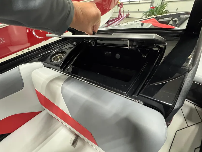 Slide: The Image of 2020 Malibu Wakesetter 22 LSV interior storage compartment with red and gray seating. - 17