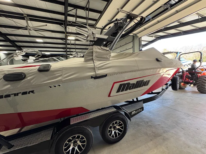 Slide: The Image of 2020 Malibu Wakesetter 22 LSV boat covered in a garage. - 23