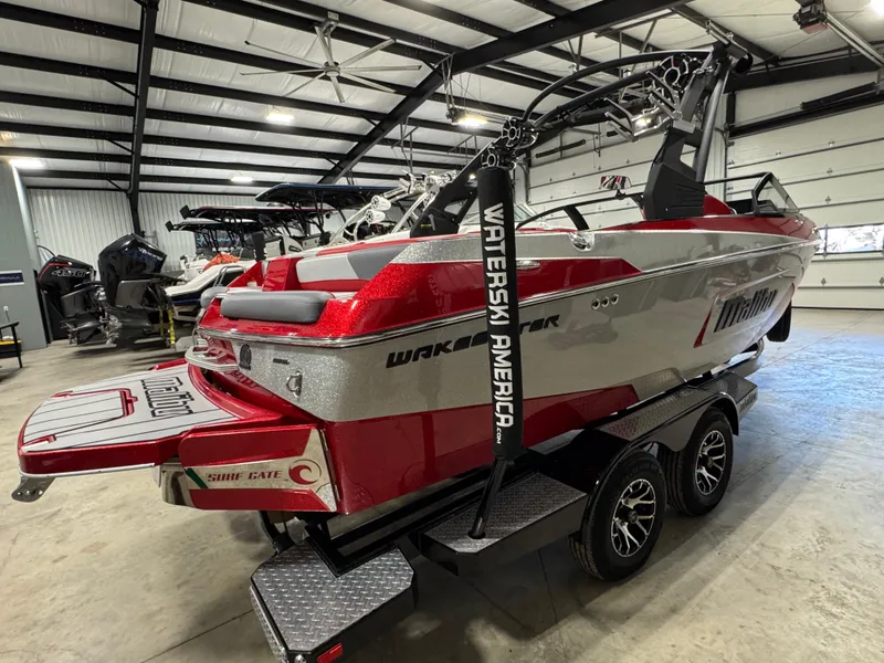 Slide: The Image of 2020 Malibu Wakesetter 22 LSV boat in showroom, red and silver design, on trailer. - 3