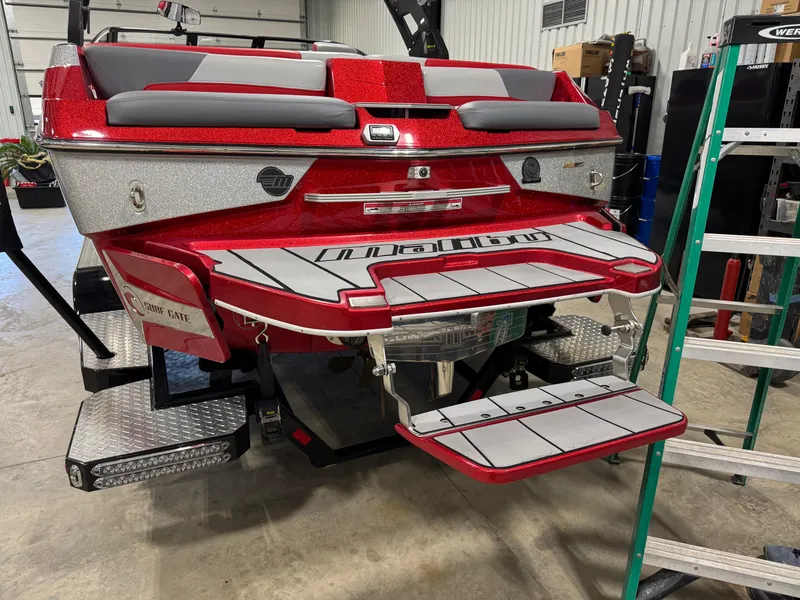 Slide: The Image of 2020 Malibu Wakesetter 22 LSV, red and gray, rear view in a garage setting. - 4