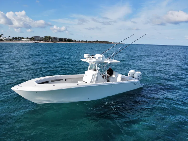 Slide: The Image of 2017 SeaVee 340Z boat on open water, clear sky, fishing rods visible. - 2