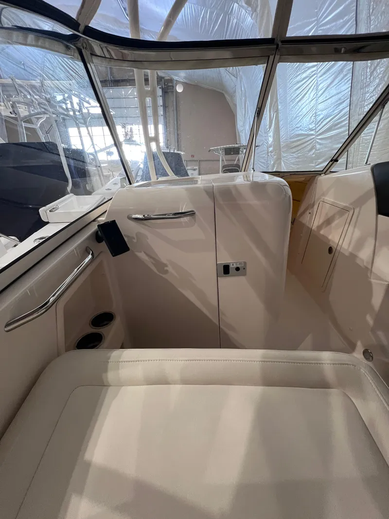 Slide: The Image of 2021 Grady-White Freedom 285 boat interior with white seating and modern design. - 10