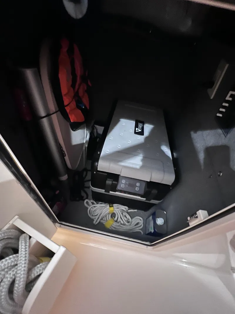 Slide: The Image of 2021 Grady-White Freedom 285 storage area with equipment and ropes. - 11