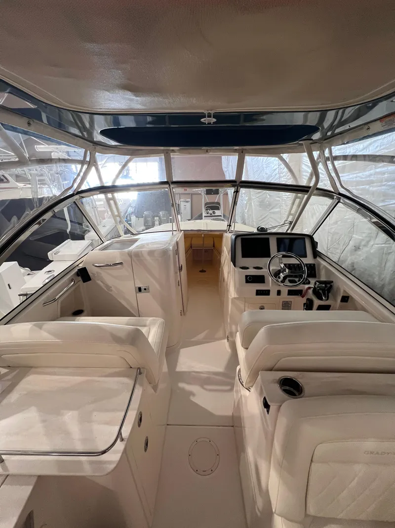 Slide: The Image of 2021 Grady-White Freedom 285 boat interior with helm, seating, and navigation equipment. - 8