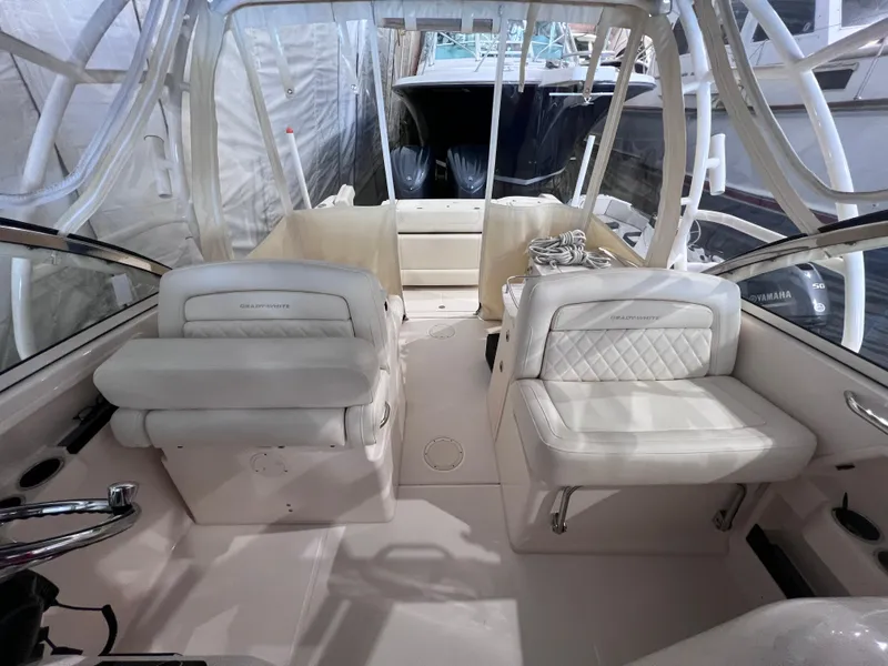 Slide: The Image of 2021 Grady-White Freedom 285 boat interior with white seating and helm. - 9