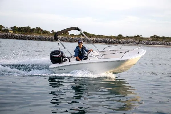 Slide: The Image of 2024 Boston Whaler 130 SUPERSPORT cruising on calm waters. - 7