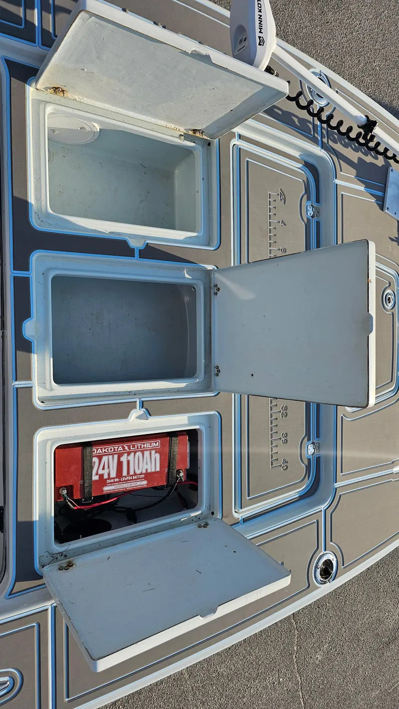 Slide: The Image of Open storage compartments on a 1992 Talon F-20 boat deck. - 12