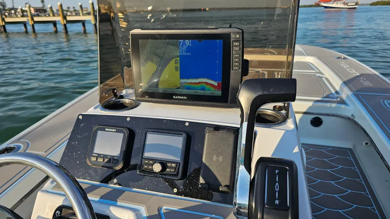 Slide: The Image of Boat dashboard with navigation equipment on a 1992 Talon F-20, dock and water in background. - 15