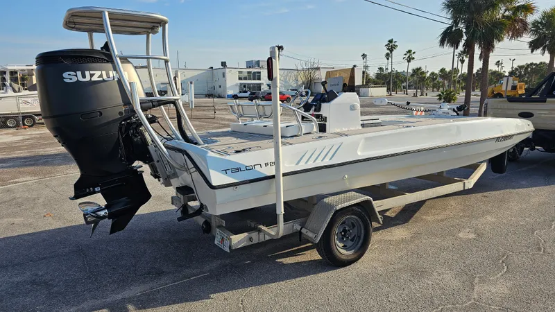 Slide: The Image of 1992 Talon F-20 boat on trailer with Suzuki outboard motor, parked outdoors. - 3