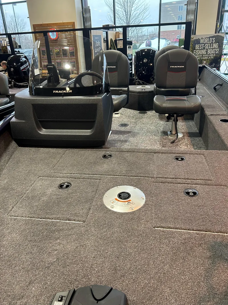 Slide: The Image of 2025 Tracker Pro Guide V-16 SC boat interior with seating and control console. - 2