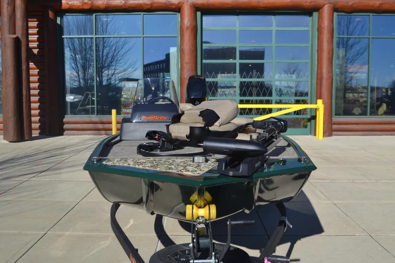 Slide: The Image of 2025 Tracker Bass Tracker Classic Limited boat parked outside a building. - 2