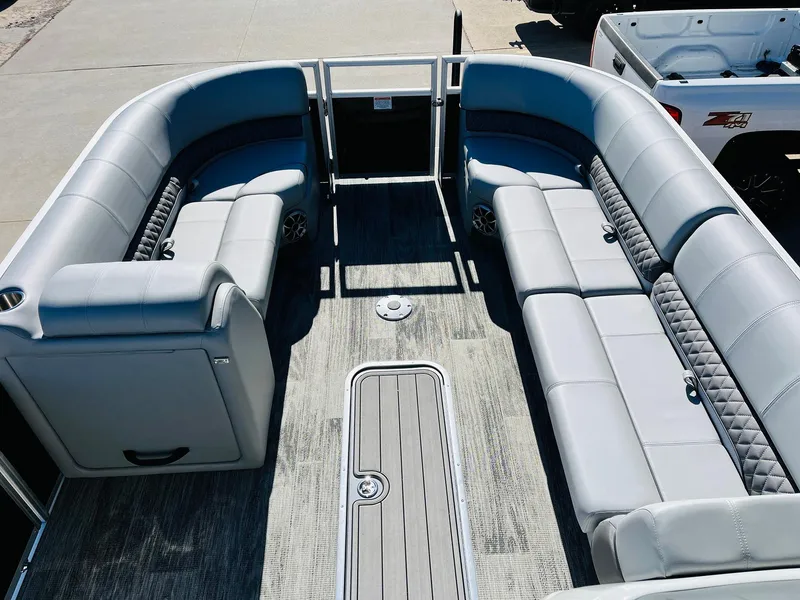 Slide: The Image of 2025 Ranger Reata 223C pontoon boat interior with spacious seating and modern design. - 10