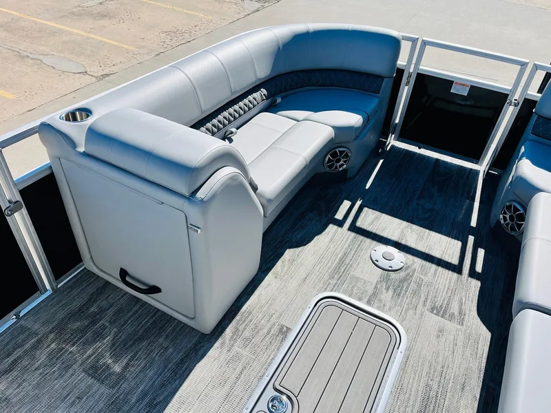Slide: The Image of 2025 Ranger Reata 223C pontoon boat interior with gray seating and carpeted flooring. - 11