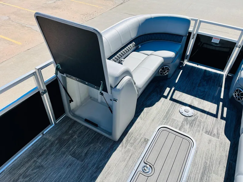 Slide: The Image of 2025 Ranger Reata 223C pontoon boat interior with gray seating and carpeted flooring. - 12