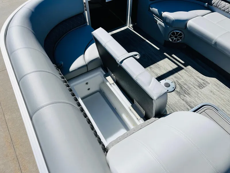Slide: The Image of 2025 Ranger Reata 223C boat interior with gray seating and storage compartment. - 15