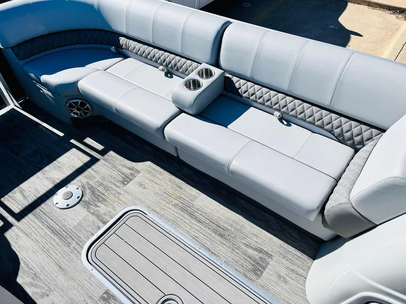 Slide: The Image of 2025 Ranger Reata 223C boat interior with gray seating and cup holders. - 17