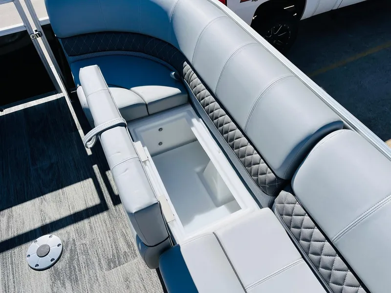 Slide: The Image of 2025 Ranger Reata 223C boat seating with storage compartment, featuring gray upholstery and diamond stitching. - 20