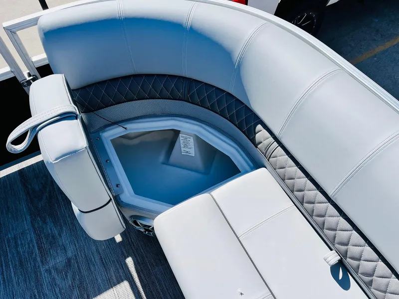 Slide: The Image of 2025 Ranger Reata 223C boat seating with storage compartment, featuring gray upholstery and diamond stitching. - 21