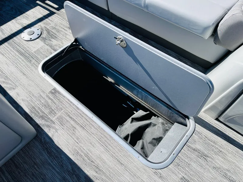 Slide: The Image of Open storage compartment on 2025 Ranger Reata 223C boat, featuring sleek design and ample space. - 23