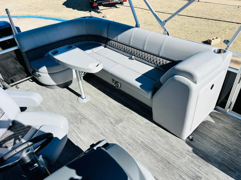 Slide: The Image of 2025 Ranger Reata 223C boat interior with gray seating and table. - 24