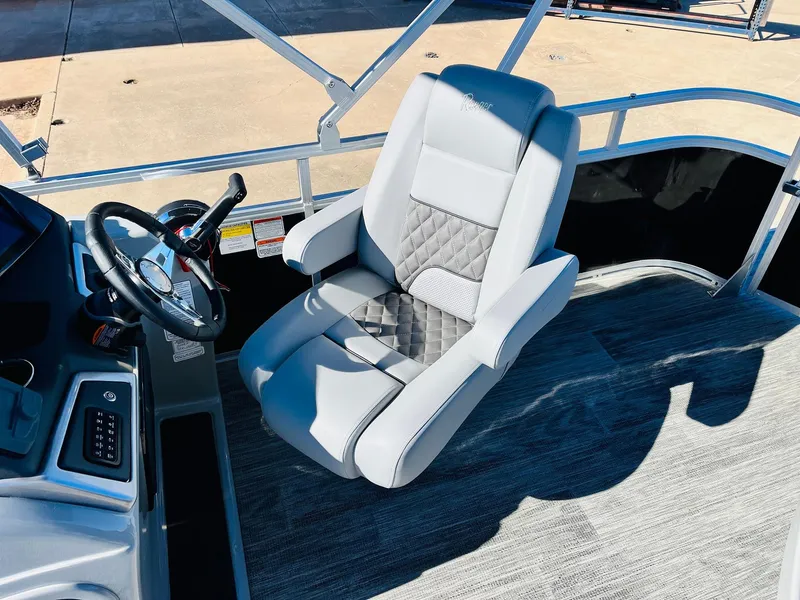 Slide: The Image of Captain's chair on 2025 Ranger Reata 223C boat, featuring sleek design and modern controls. - 27